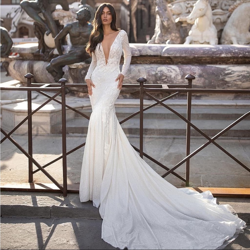 Milla Nova gorgeous flower embroidered long sleeve wedding gown.